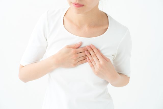 胸をおさえる女性